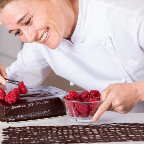 Pastry,Chef,In,The,Kitchen,Decorating,A,Cake,Of,Chocolate
